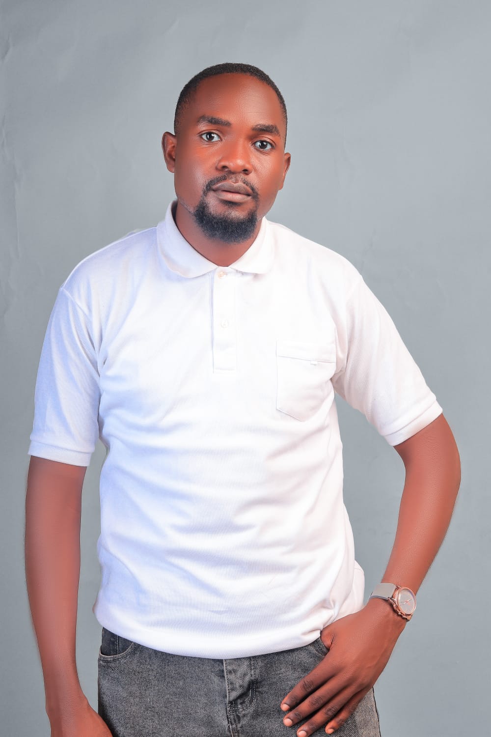 Dismus Nganyi in a white polo shirt, smiling slightly